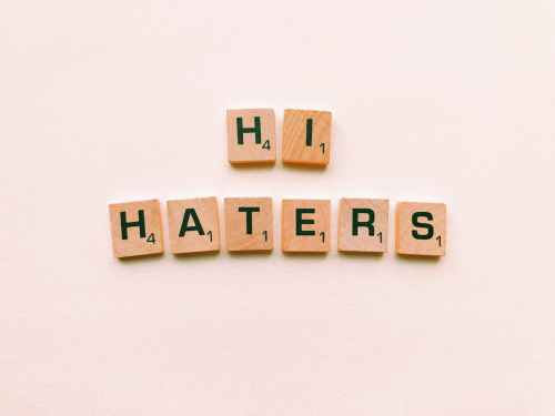 hi haters scrabble tiles on white surface