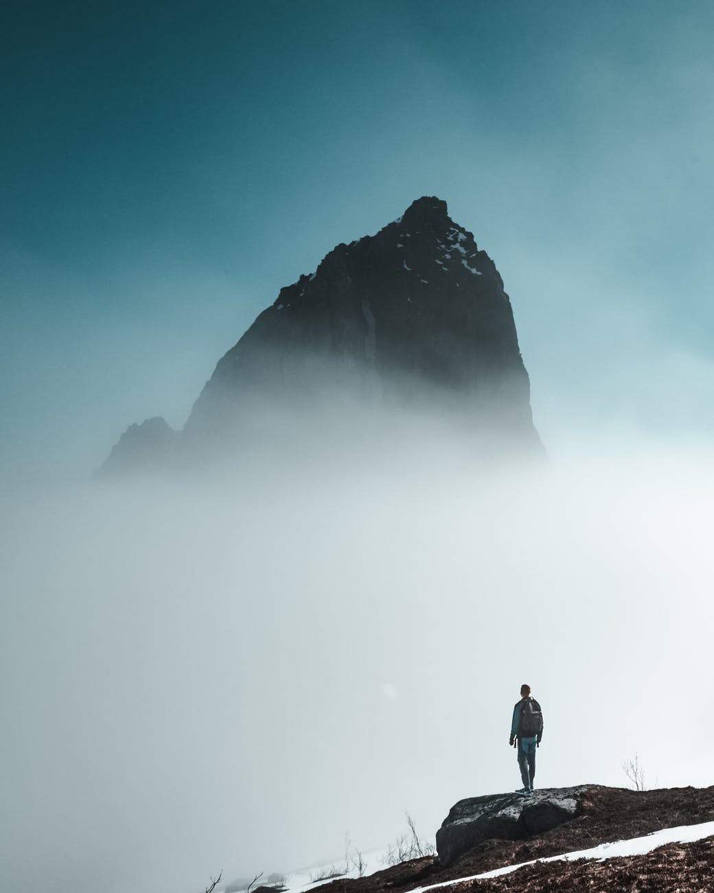 man looking at a rock formation